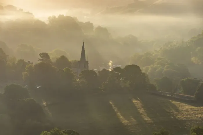 Framed Print : Hathersage church surrounded by the hills of the Peak District at sunrise. UK