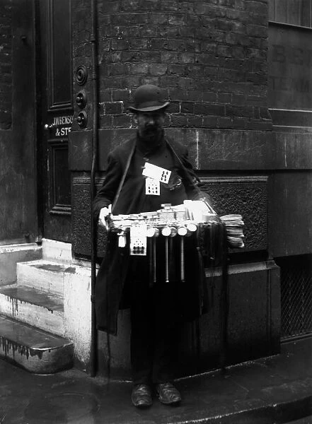 Hawker. November 1907: A street hawker with Christmas toys on Ludgate Hill, London