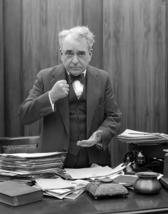 Framed Print : Head-On Picture Of Angry Businessman, Sitting Behind A Desk And Making A Fist Framed Print : Head-On Picture Of Angry Businessman, Sitting Behind A Desk And Making A Fist