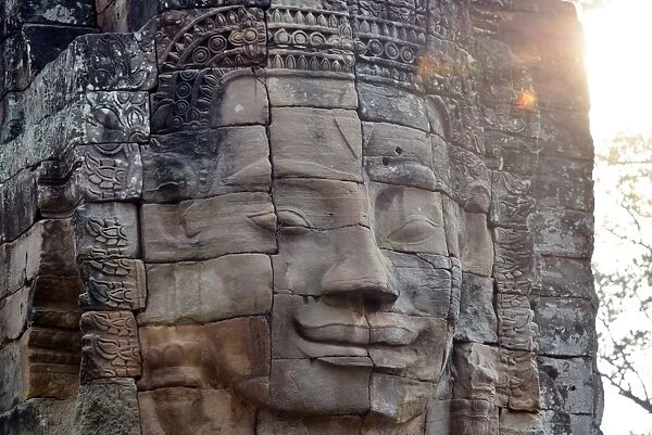 Head statue at sunrise Bayon temple angkor unesco Siem Reap Cambodia