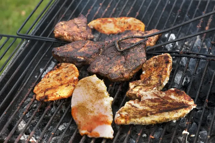 Framed Print : Heavily roasted meat on a charcoal grill