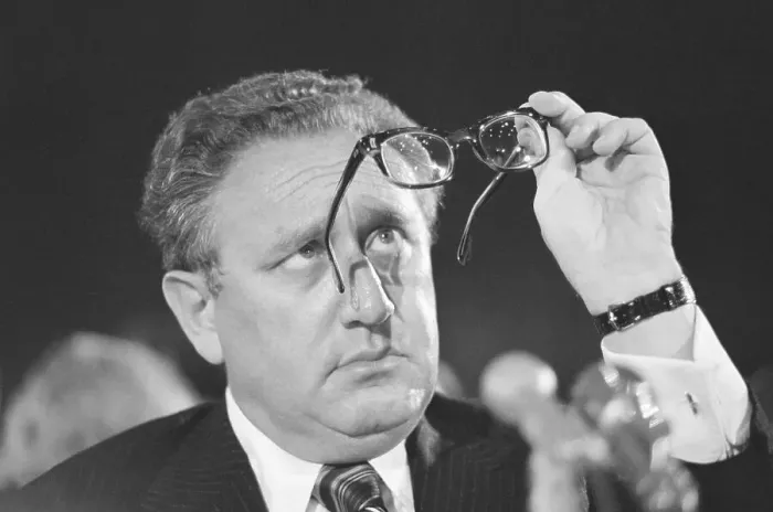 Framed Print : Henry Kissinger Looking at Glasses