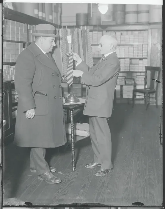 Framed Print : Henry Siegel Choosing a Necktie for Customer Framed Print : Henry Siegel Choosing a Necktie for Customer