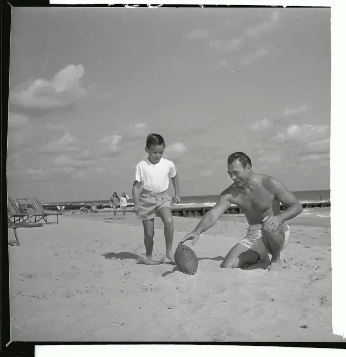 Framed Print : Herschel Martin Holding Football for Young Boy Framed Print : Herschel Martin Holding Football for Young Boy