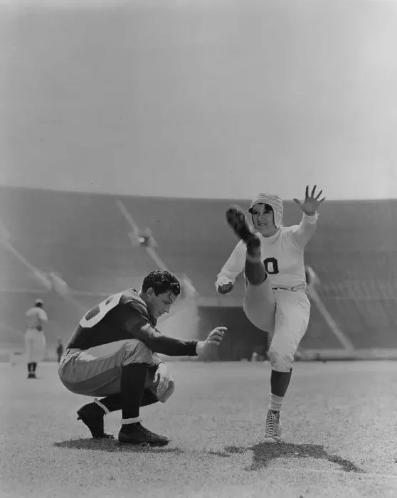 Framed Print : High Kick. 1938: Joan Davis doing a high-kick on the football field, in a scene Framed Print : High Kick. 1938: Joan Davis doing a high-kick on the football field, in a scene