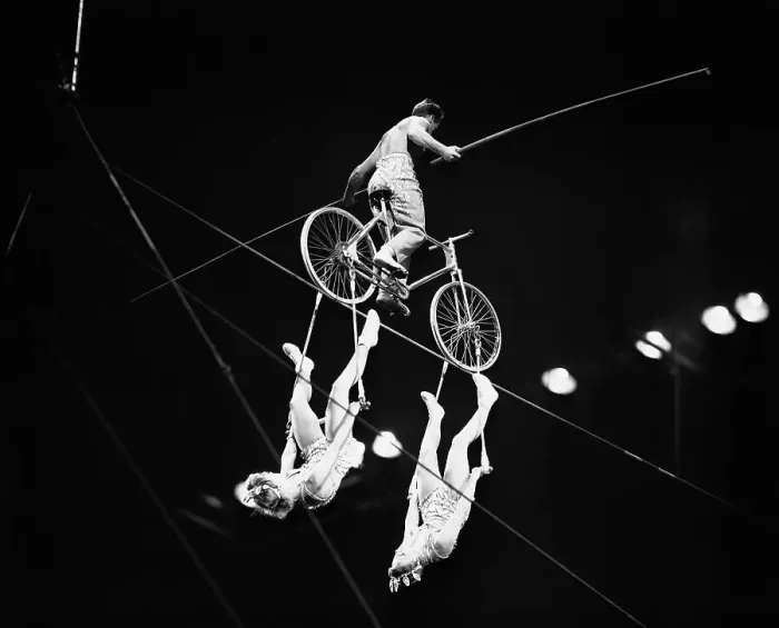 Framed Print : Highwire Bicyclist Balances Two Women Below Bicycle Framed Print : Highwire Bicyclist Balances Two Women Below Bicycle