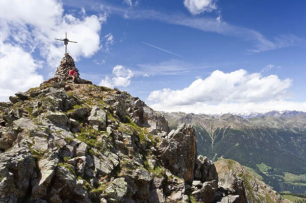 Hiker on the summit of Spitzen Kornigls Mountain, overlooking the Val dUltimo, Ultimo, Alto Adige, Italy, Europe