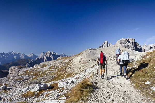 Hikers on the Buellelejoch Pass during the ascent to Paternkofel Mountain, looking towards Paternkofel Mountain, the Three Peaks and the Cadini Group, Sesto, Alta Pusteria, Dolomites, Alto Adige, Italy, Europe