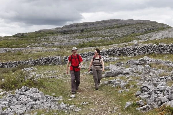 Hikers in Burren National Park, County Clare, Ireland, Europe
