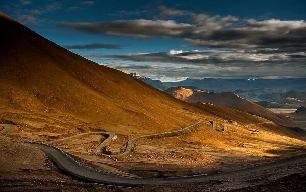 hill side meandering road on tibetan plateau