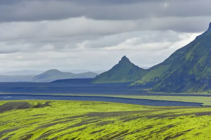 Framed Print : Hills covered with moss in front of an area with black sand and a pointed mountain, view from the road into the Pakgil or Thakgil Valley, Iceland