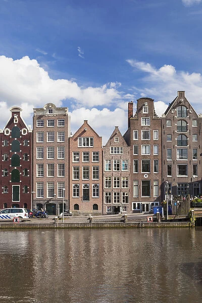 Historic buildings along the Damrak canal in Amsterdam, Holland, Netherlands, Europe