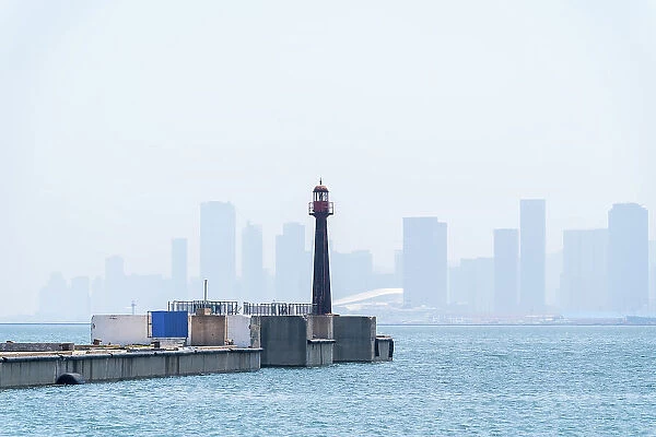 Historical Lighthouse and Dalian Bay with City Skyline in Background