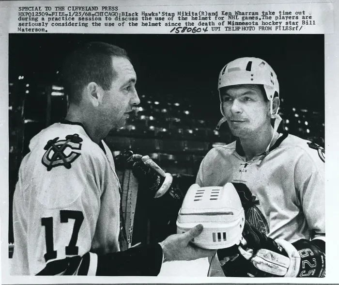 Framed Print : Hockey Teammates Examining Helmet Framed Print : Hockey Teammates Examining Helmet