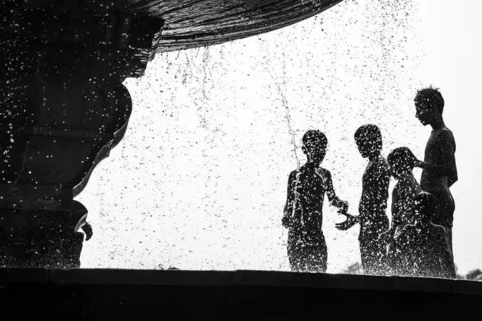 Framed Print : Too Hot. Many boys relax from hot air by water fountain in the Delhis public park Framed Print : Too Hot. Many boys relax from hot air by water fountain in the Delhis public park