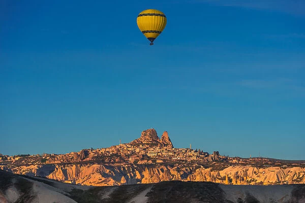 Hot air balloon over cappadocia rock landscape