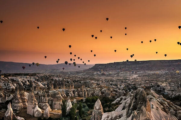 Hot air balloon flying over rock