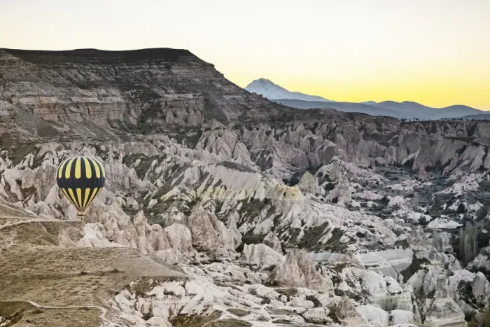 Framed Print : Hot air balloon flying over rock landscape at Cappadocia, Turkey Framed Print : Hot air balloon flying over rock landscape at Cappadocia, Turkey
