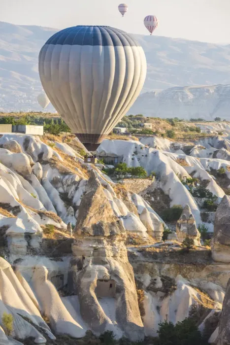Framed Print : Hot air balloon flying over rock landscape at Cappadocia Turkey