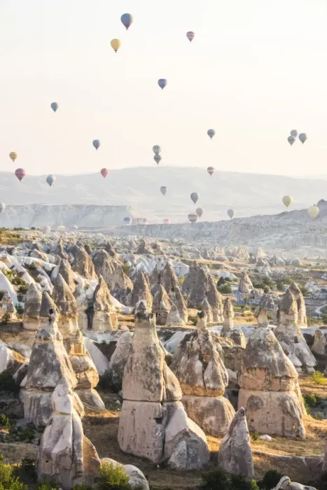 Framed Print : Hot air balloon flying over rock landscape at Cappadocia Turkey