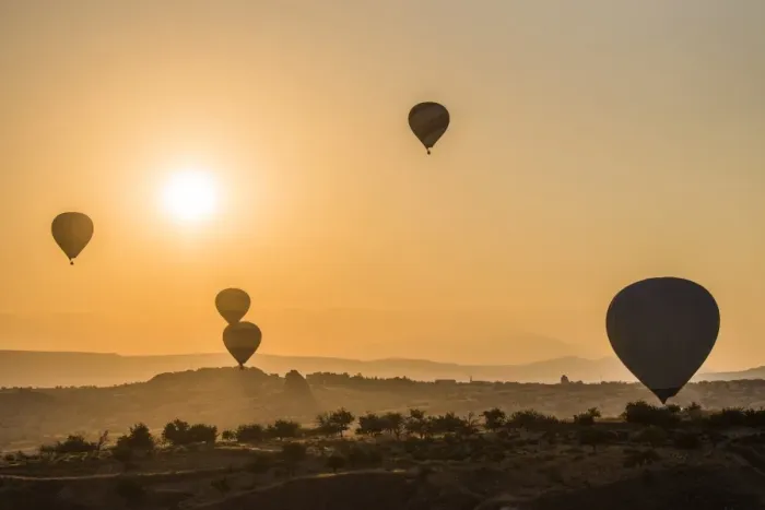Framed Print : Hot air balloon flying over rock landscape at Cappadocia Turkey