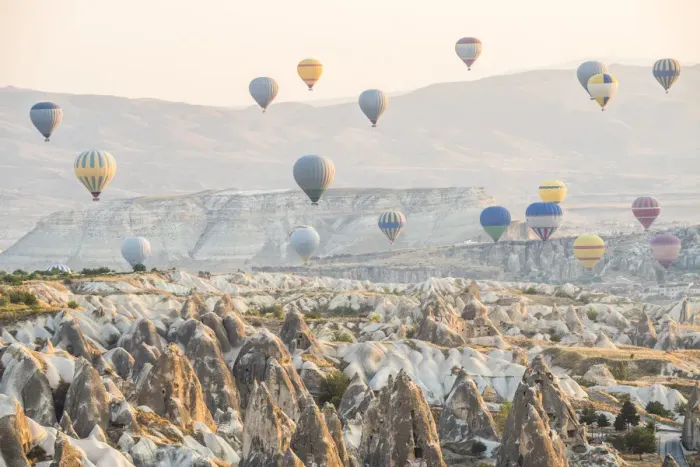 Framed Print : Hot air balloon flying over rock landscape at Cappadocia Turkey Framed Print : Hot air balloon flying over rock landscape at Cappadocia Turkey