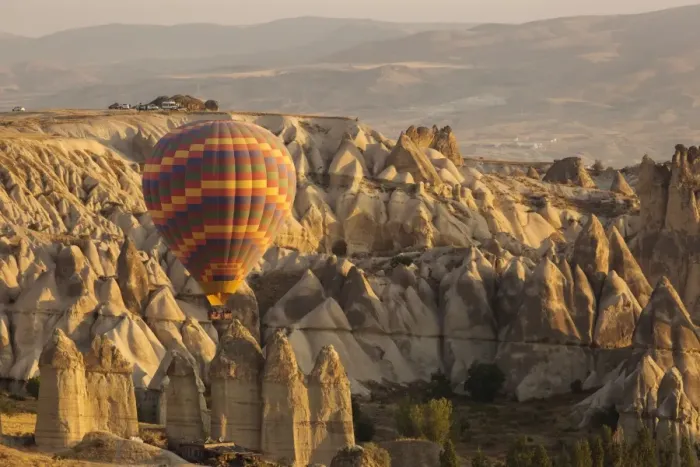 Framed Print : Hot air balloon flying over rock landscape at Cappadocia Turkey Framed Print : Hot air balloon flying over rock landscape at Cappadocia Turkey