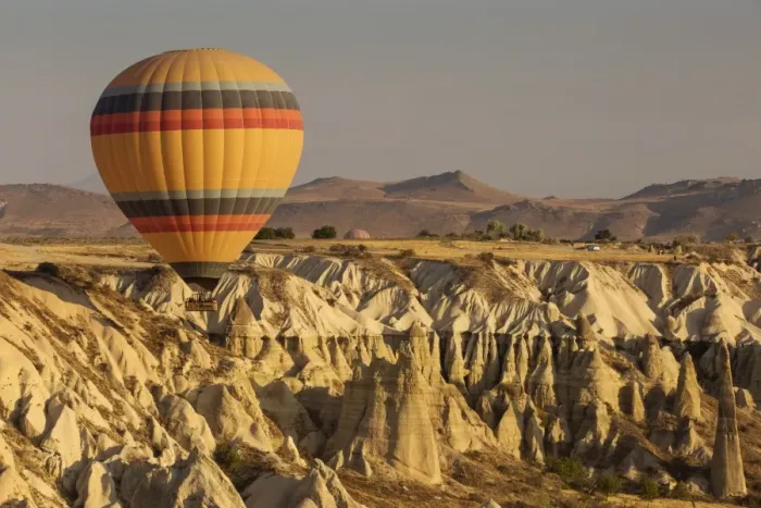 Framed Print : Hot air balloon flying over rock landscape at Cappadocia Turkey Framed Print : Hot air balloon flying over rock landscape at Cappadocia Turkey