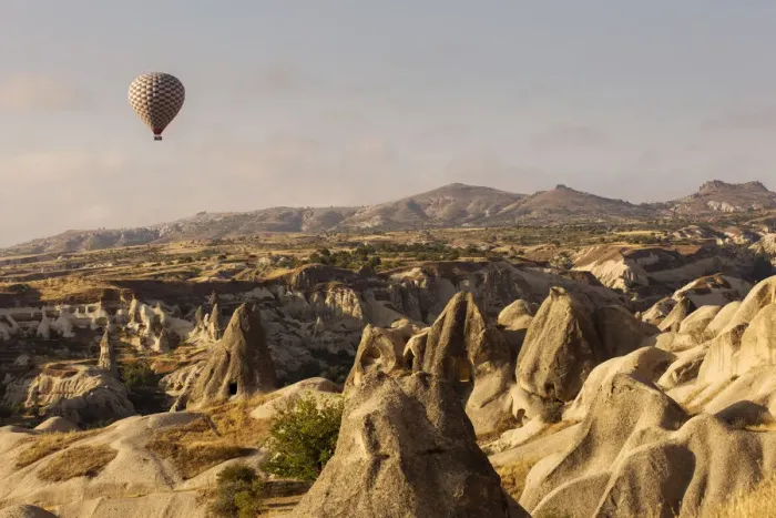 Framed Print : Hot air balloon flying over rock landscape at Cappadocia Turkey Framed Print : Hot air balloon flying over rock landscape at Cappadocia Turkey