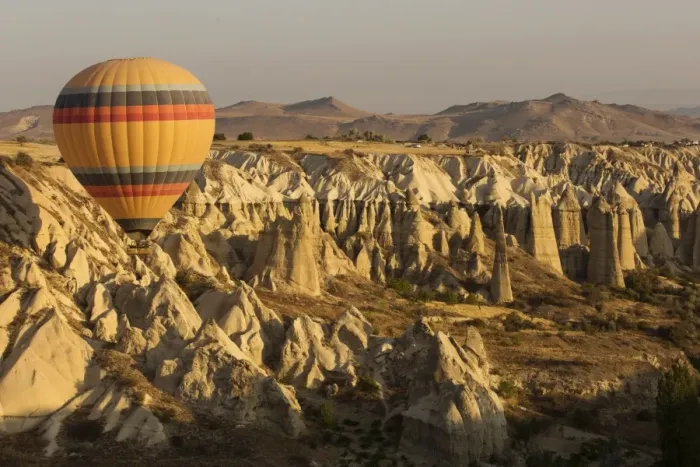Framed Print : Hot air balloon flying over rock landscape at Cappadocia Turkey Framed Print : Hot air balloon flying over rock landscape at Cappadocia Turkey
