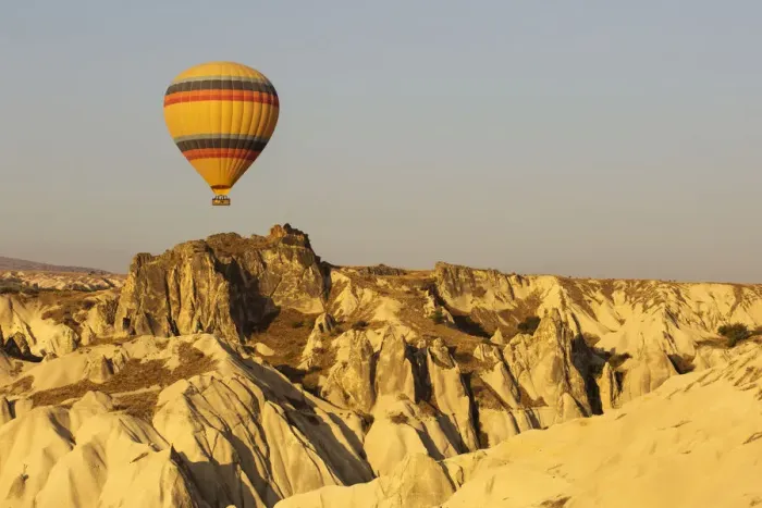 Framed Print : Hot air balloon flying over rock landscape at Cappadocia Turkey Framed Print : Hot air balloon flying over rock landscape at Cappadocia Turkey