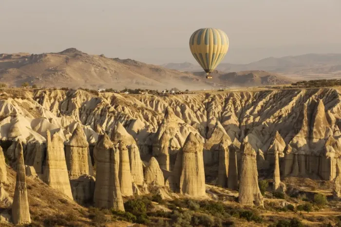 Framed Print : Hot air balloon flying over rock landscape at Cappadocia Turkey Framed Print : Hot air balloon flying over rock landscape at Cappadocia Turkey