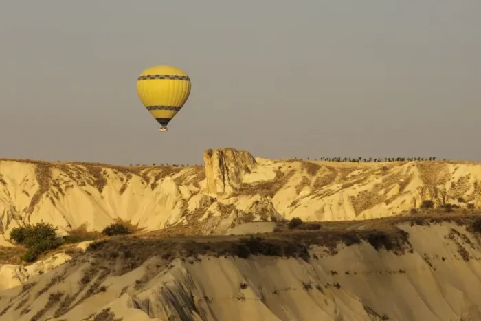 Framed Print : Hot air balloon flying over rock landscape at Cappadocia Turkey Framed Print : Hot air balloon flying over rock landscape at Cappadocia Turkey