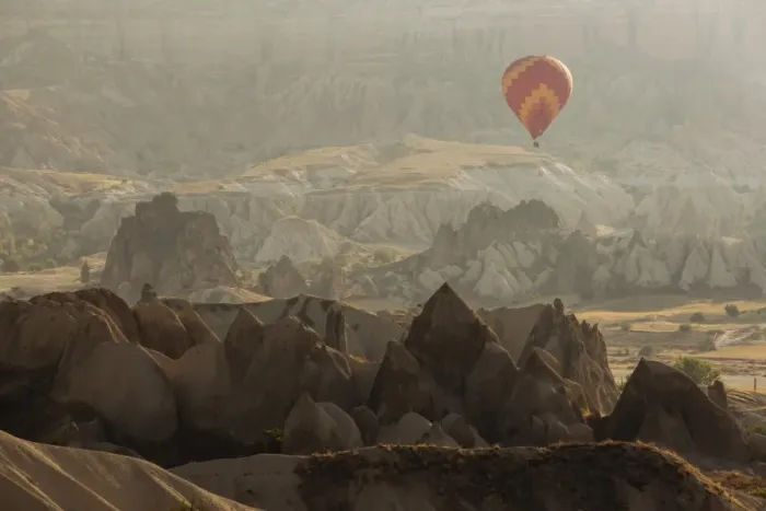 Framed Print : Hot air balloon flying over rock landscape at Cappadocia Turkey Framed Print : Hot air balloon flying over rock landscape at Cappadocia Turkey