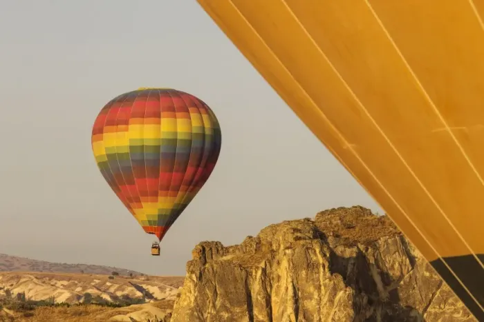 Framed Print : Hot air balloon flying over rock landscape at Cappadocia Turkey