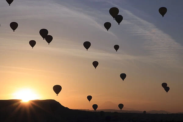 Hot air balloons flying above rock formations, Goreme National Park, Goreme, Cappadocia, Anatolia, Turkey