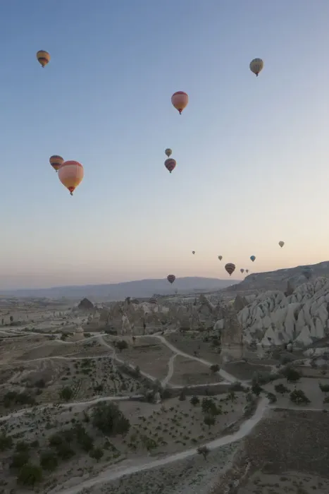 Framed Print : Hot air balloons flying over rocky landscape