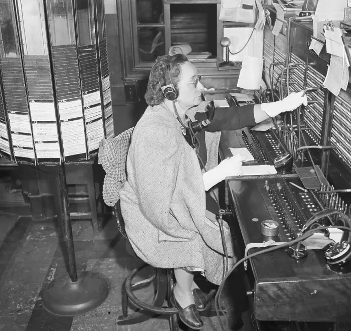 Framed Print : Hotel Switchboard Operator in Coat and Gloves