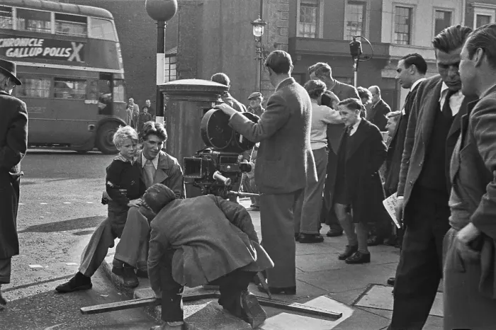Framed Print : Hunted. Scottish child actor Jon Whiteley sits on the knee of a man during Framed Print : Hunted. Scottish child actor Jon Whiteley sits on the knee of a man during