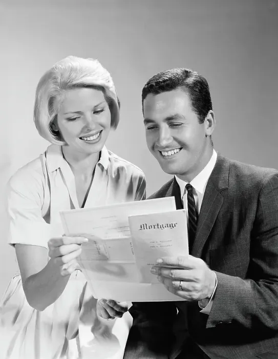 Framed Print : Husband and wife homeowners looking at mortgage and smiling