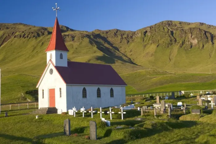 Framed Print : Iceland, church and graveyard in mountainous landscape Framed Print : Iceland, church and graveyard in mountainous landscape