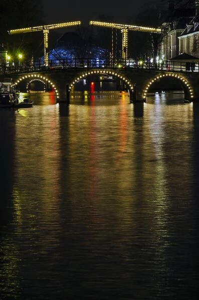 Illuminated Amsterdam Canal and Bridge