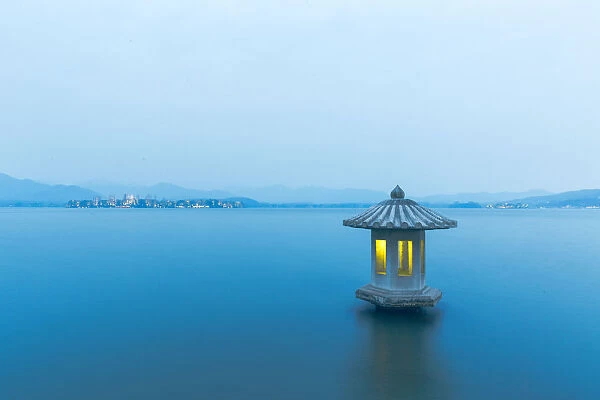 A illuminated stone lantern on the West Lake, Hangzhou, China