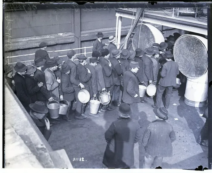 Framed Print : Immigrants in Line Holding Buckets Framed Print : Immigrants in Line Holding Buckets