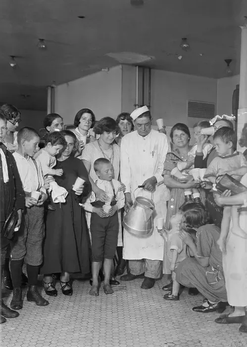 Framed Print : Immigration Worker Giving Milk to Woman and Children Framed Print : Immigration Worker Giving Milk to Woman and Children