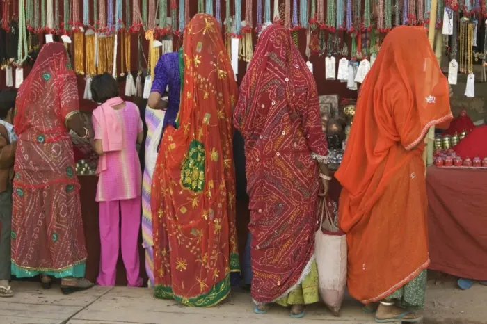 Framed Print : India, Rajasthan, Pushkar, women and girl shopping, rear view Framed Print : India, Rajasthan, Pushkar, women and girl shopping, rear view
