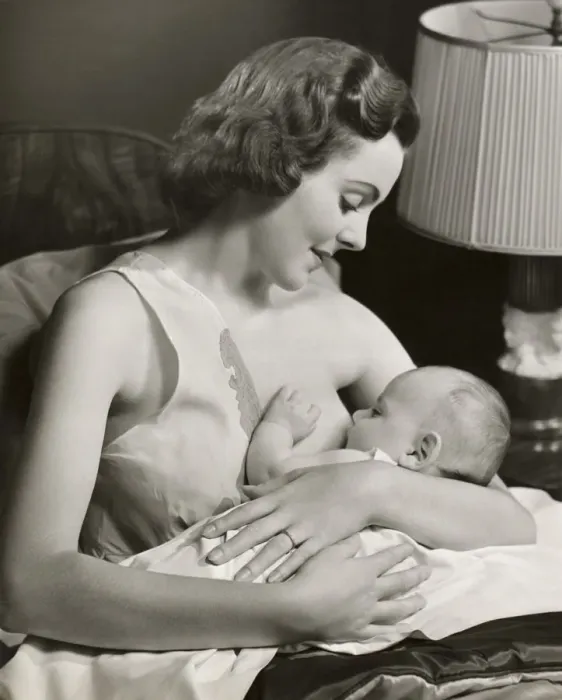 Framed Print : Infant being nursed by mother Framed Print : Infant being nursed by mother