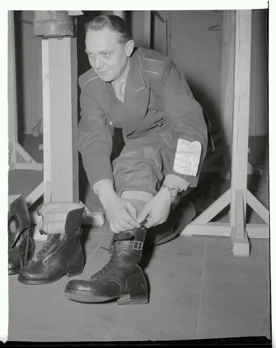 Framed Print : Infantryman Trying on Boots Framed Print : Infantryman Trying on Boots