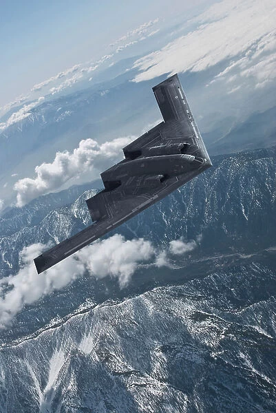 Inflight view of a USAF Northrop Grumman B-2A 'Spirit' stealth bomber over mountains