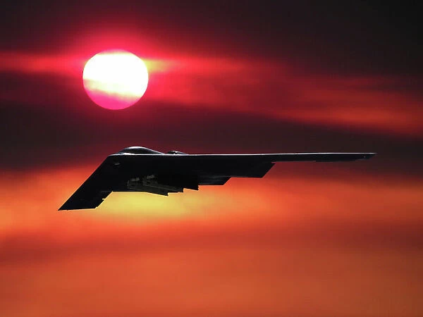Inflight view of a USAF Northrop Grumman B-2A stealth bomber in a sunset